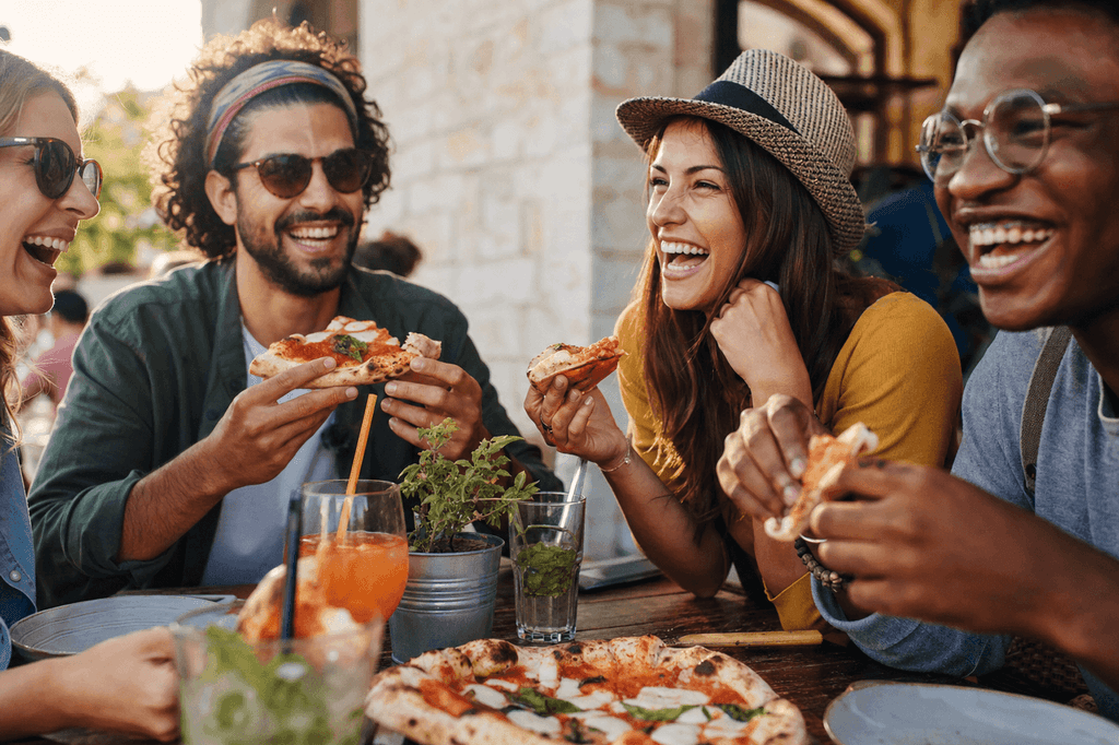Friends enjoying authentic local pizza dining experience